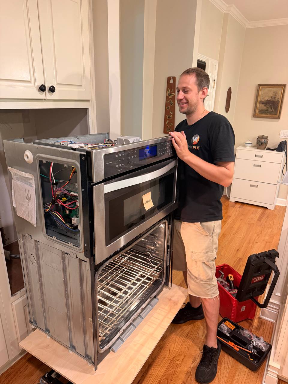 VKFIX technician working on a built-in oven