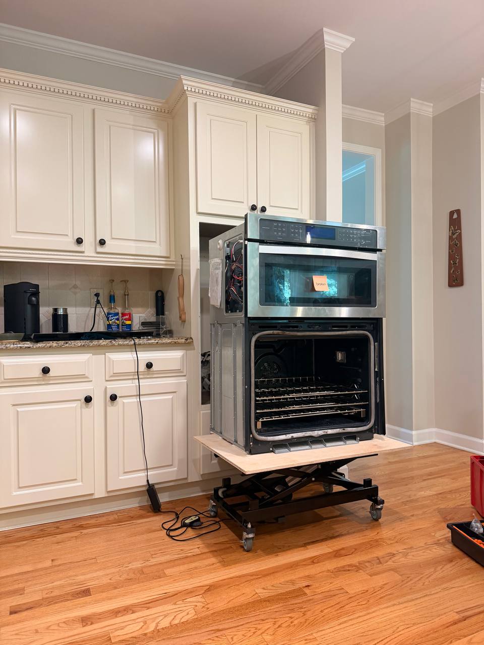 Built-in wall oven pulled out for access during service